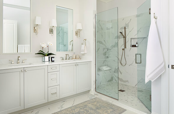 The Wade interiors, primary bathroom, light gray cabinet, marble, large shower